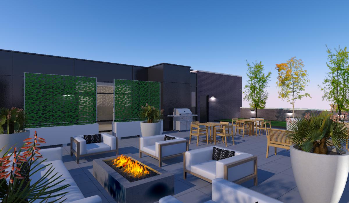Roof deck with plush outdoor seating around a fire pit and grilling area in background.